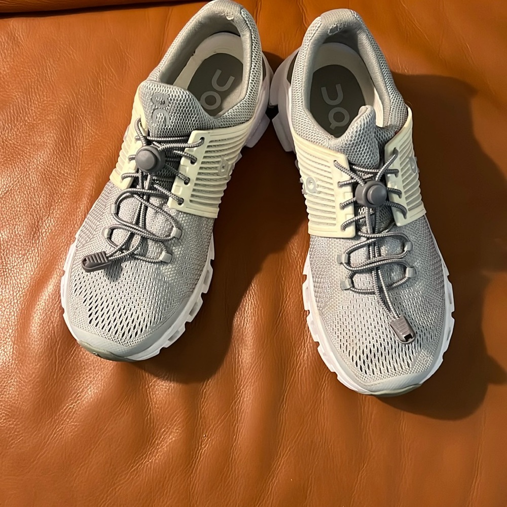 Women’s  On brand athletic shoes , gray and white mesh uppers, wavy bottom